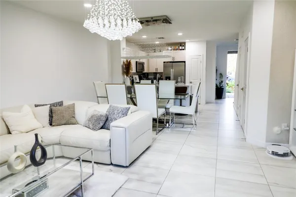 a living room with furniture and a chandelier