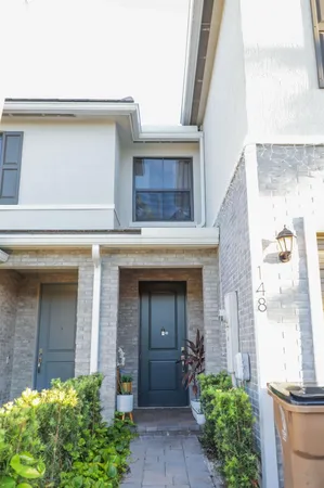 front view of a house with potted plants