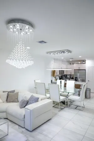 a living room with furniture and a chandelier