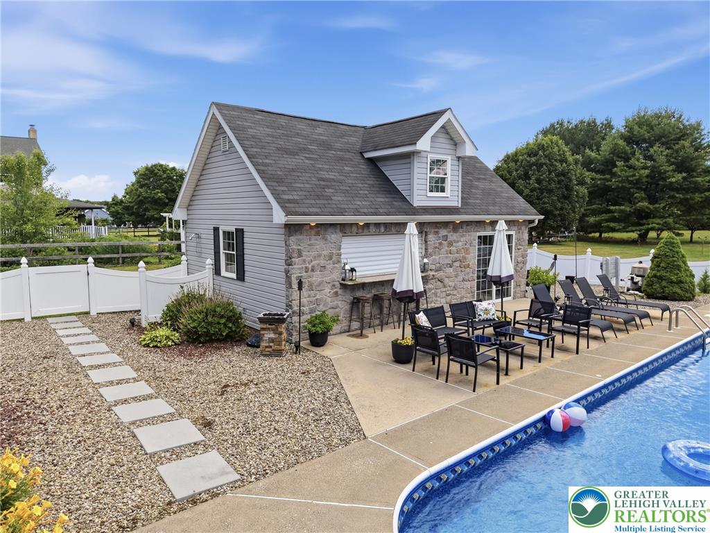 890 Lahr Road Nazareth, PA 18064 - Photo 52 of 71 An inviting poolside retreat offers a dedicated structure, ample patio space, and a well-maintained swimming pool.