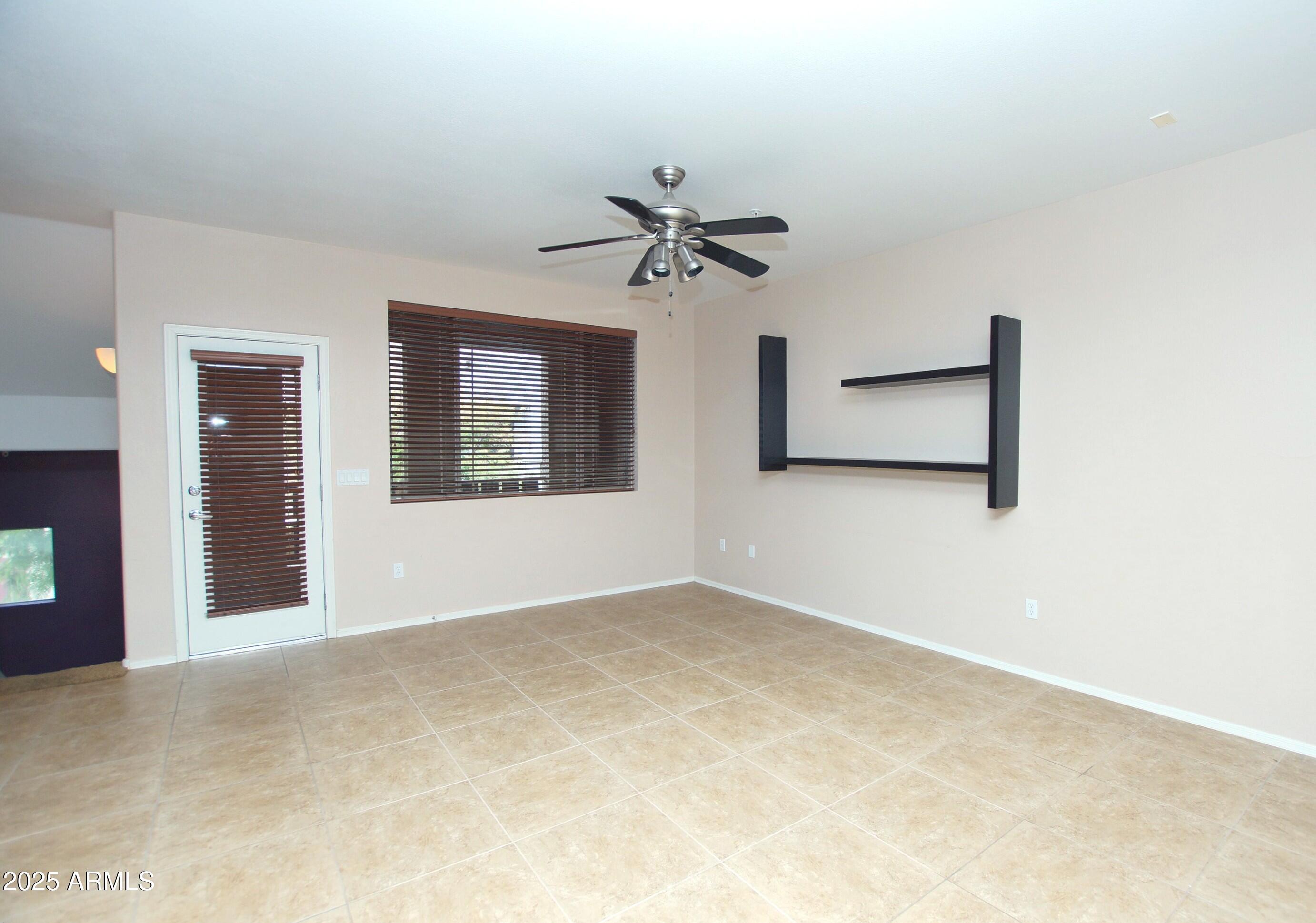 2150 West Alameda Road, Unit 1398 Phoenix, AZ 85085 - Photo 15 of 29 an empty room with chandelier fan and windows