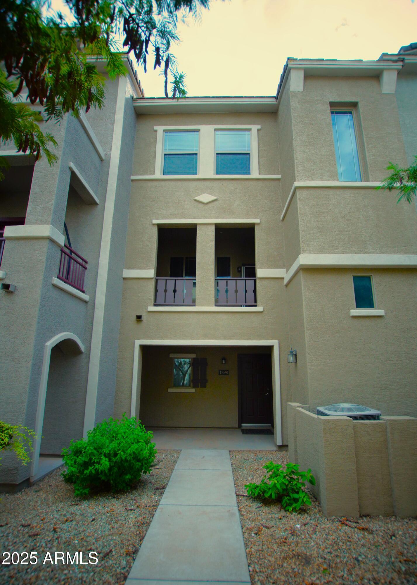 2150 West Alameda Road, Unit 1398 Phoenix, AZ 85085 - Photo 2 of 29 a front view of a house with garden