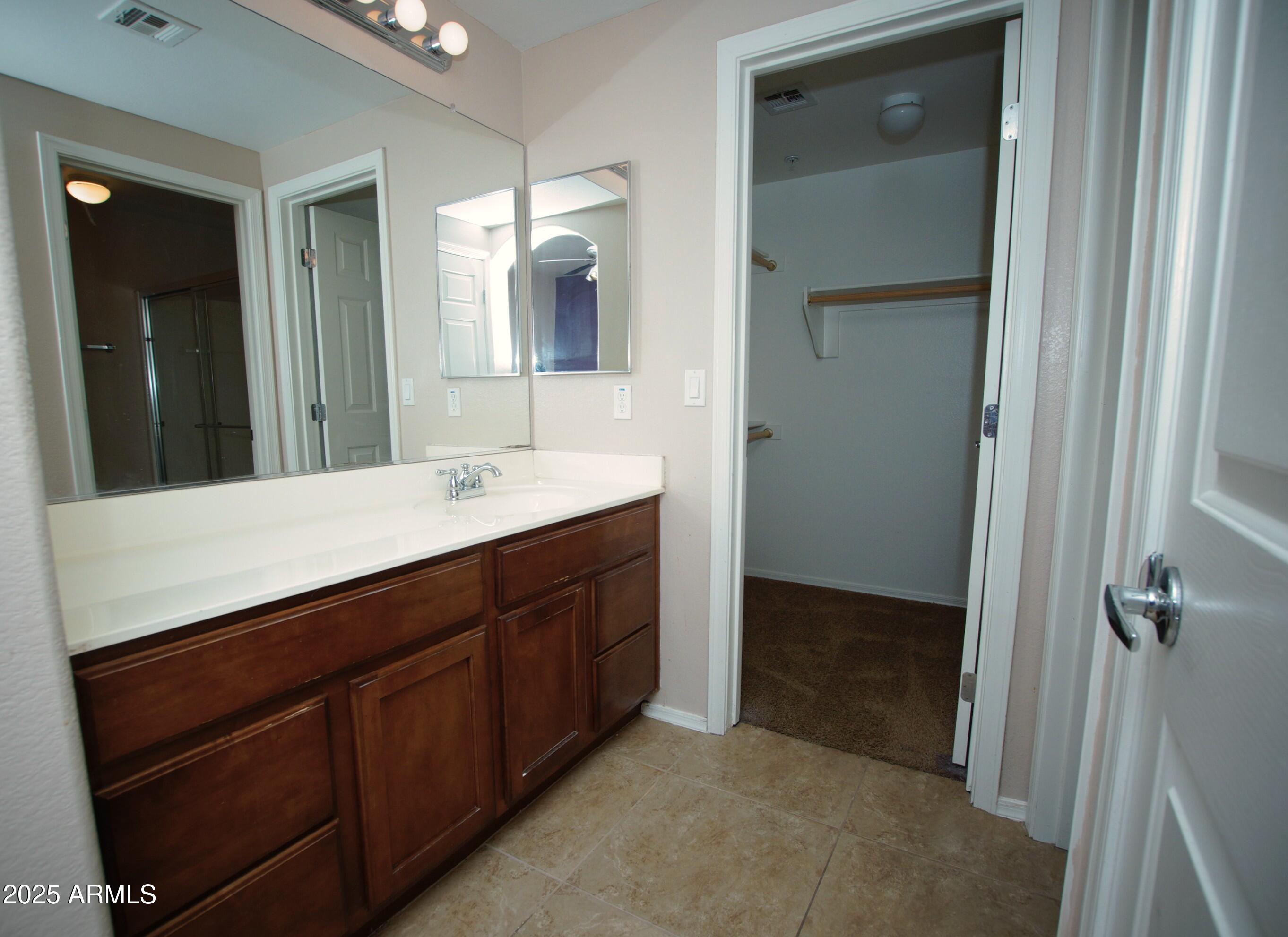 2150 West Alameda Road, Unit 1398 Phoenix, AZ 85085 - Photo 21 of 29 a bathroom with a sink a vanity and a mirror