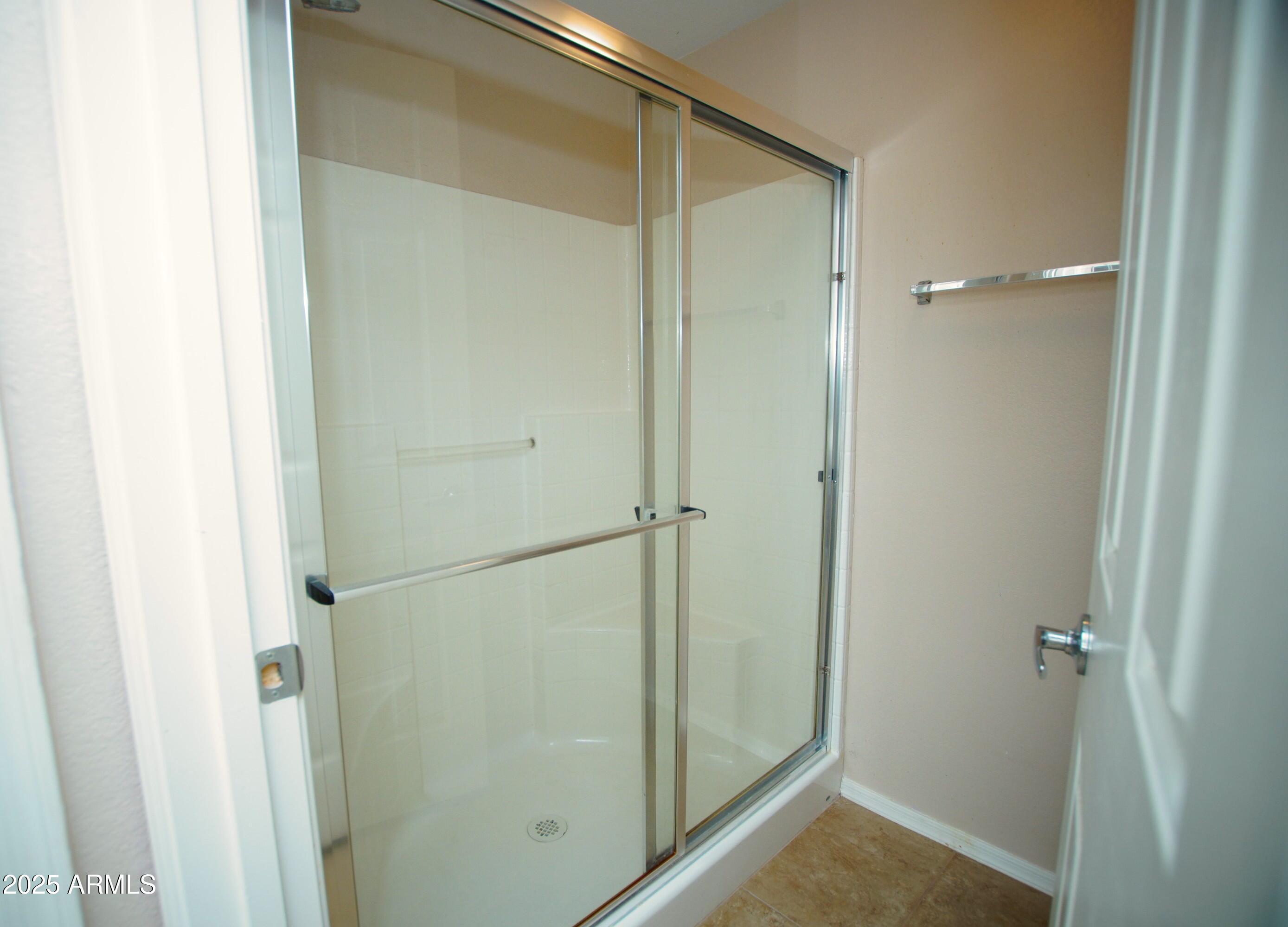 2150 West Alameda Road, Unit 1398 Phoenix, AZ 85085 - Photo 23 of 29 a bathroom with a glass shower door