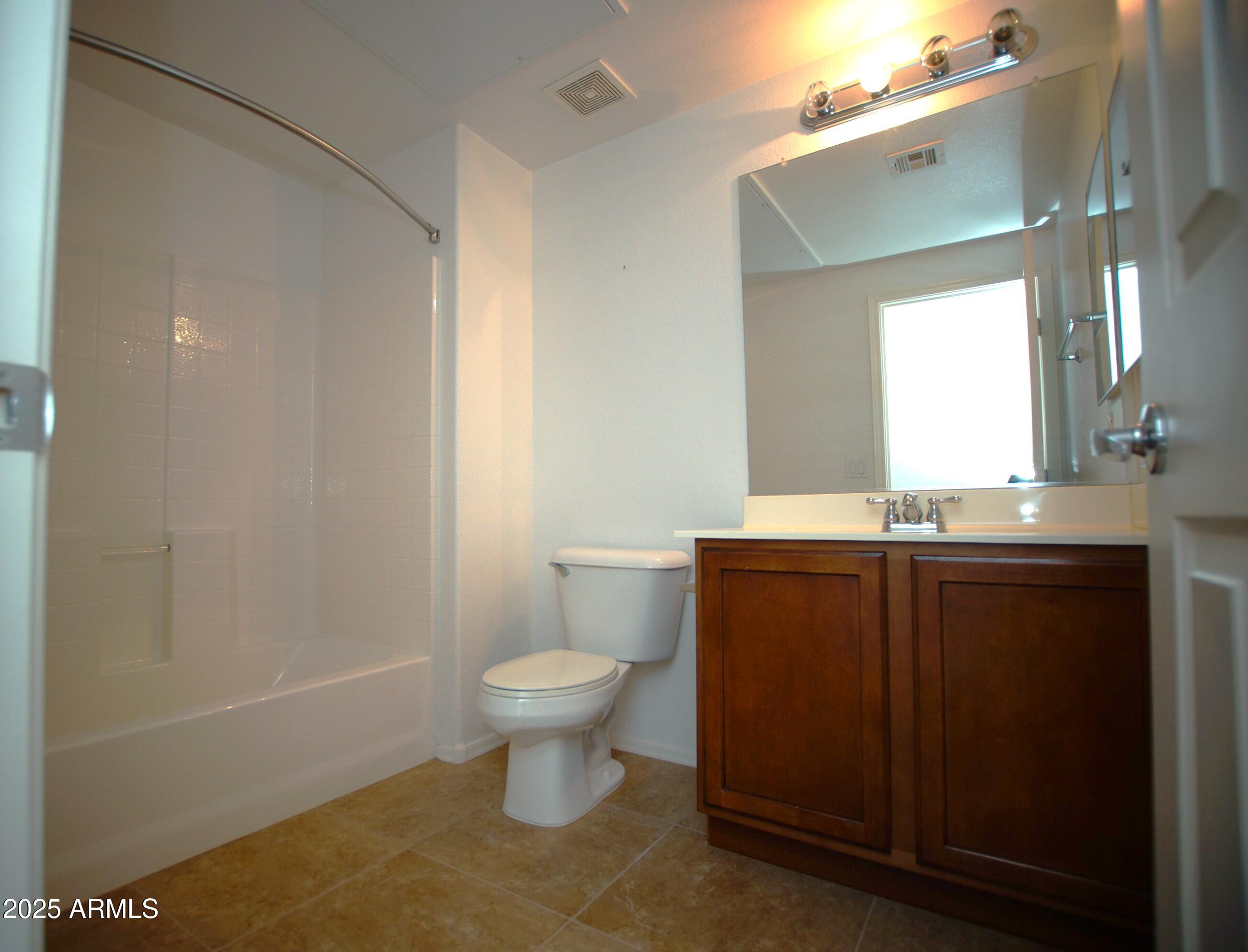 2150 West Alameda Road, Unit 1398 Phoenix, AZ 85085 - Photo 24 of 29 a bathroom with a sink a toilet a mirror and vanity
