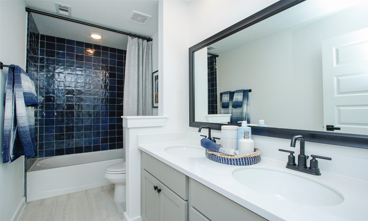 4028 Colony Riv Rock Boulevard Pinehurst, TX 77362 - Photo 18 of 21 a bathroom with a sink a toilet and shower