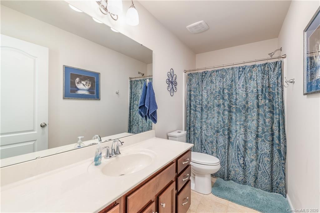 78094 Rillstone Drive Lancaster, SC 29720 - Photo 15 of 26 a bathroom with a sink a toilet and shower curtain