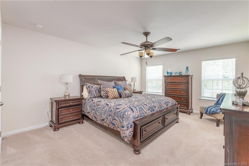 78094 Rillstone Drive Lancaster, SC 29720 - Photo 18 of 26 a spacious bedroom with a bed and a chandelier
