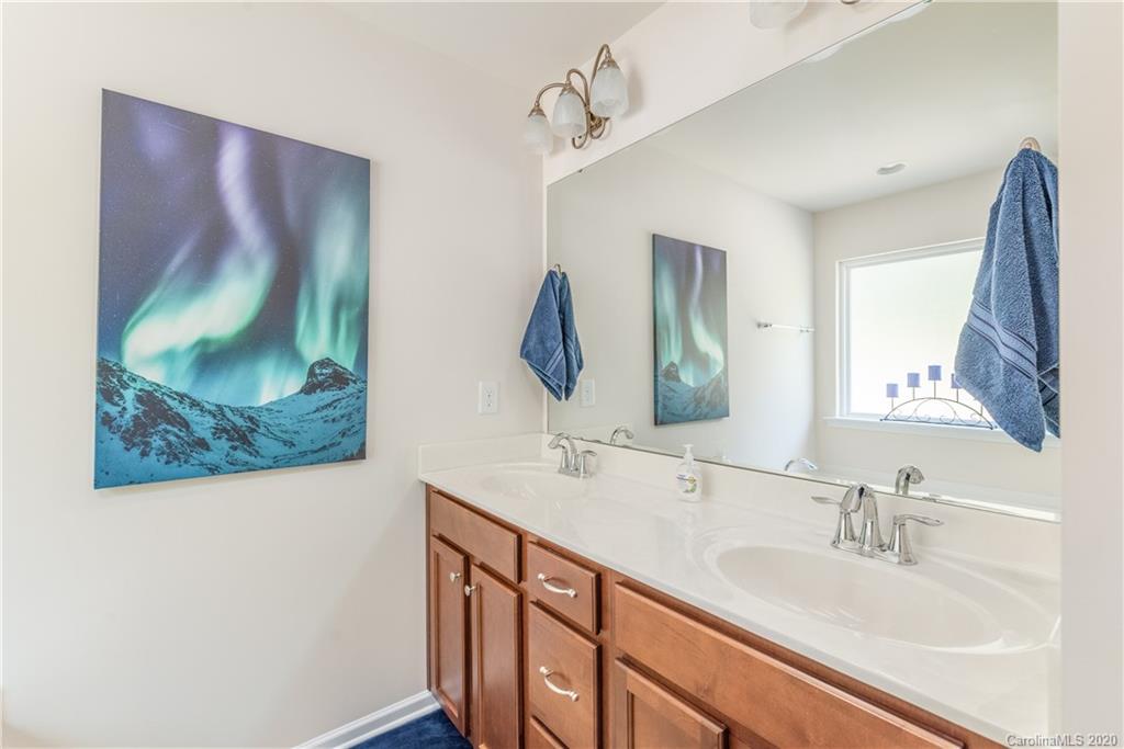 78094 Rillstone Drive Lancaster, SC 29720 - Photo 19 of 26 a bathroom with a double vanity sink and a mirror