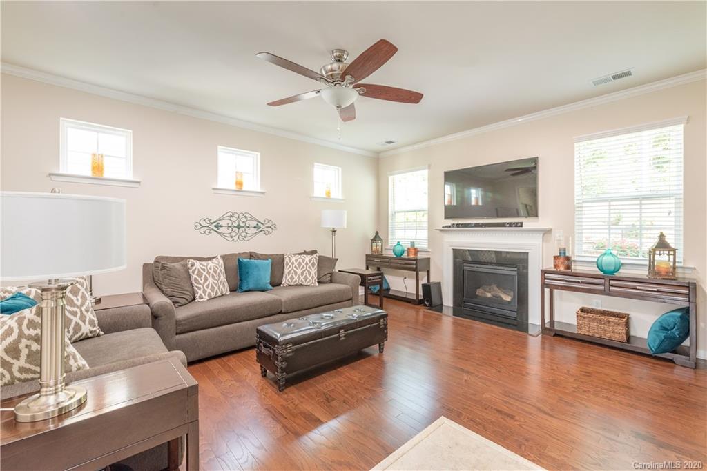78094 Rillstone Drive Lancaster, SC 29720 - Photo 7 of 26 a living room with furniture a fireplace and a flat screen tv