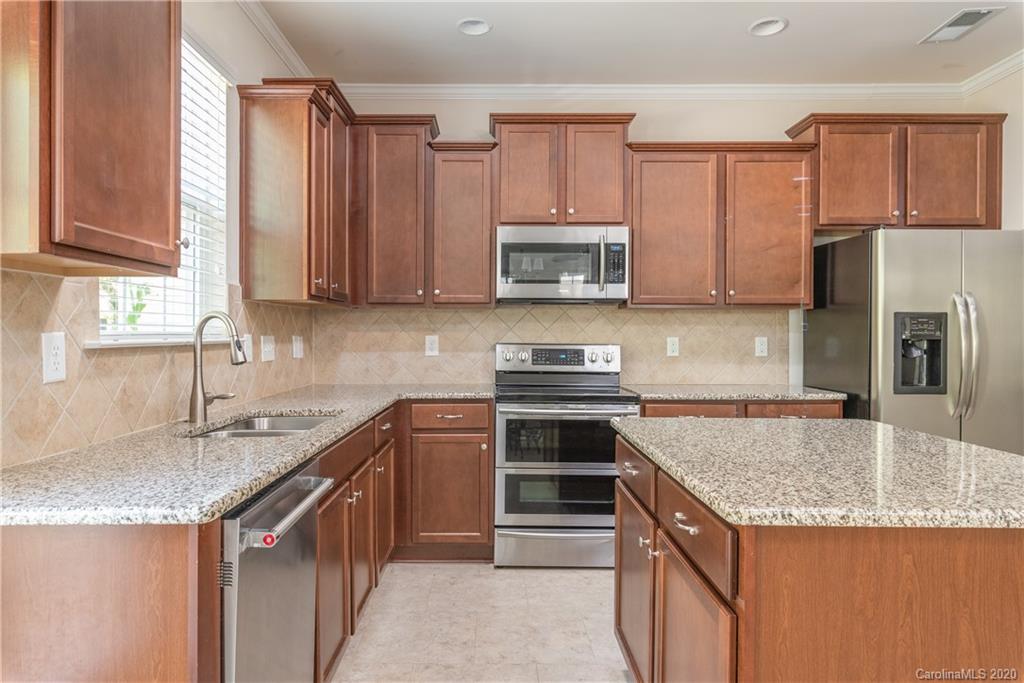 78094 Rillstone Drive Lancaster, SC 29720 - Photo 10 of 26 a kitchen with stainless steel appliances granite countertop a sink stove and microwave