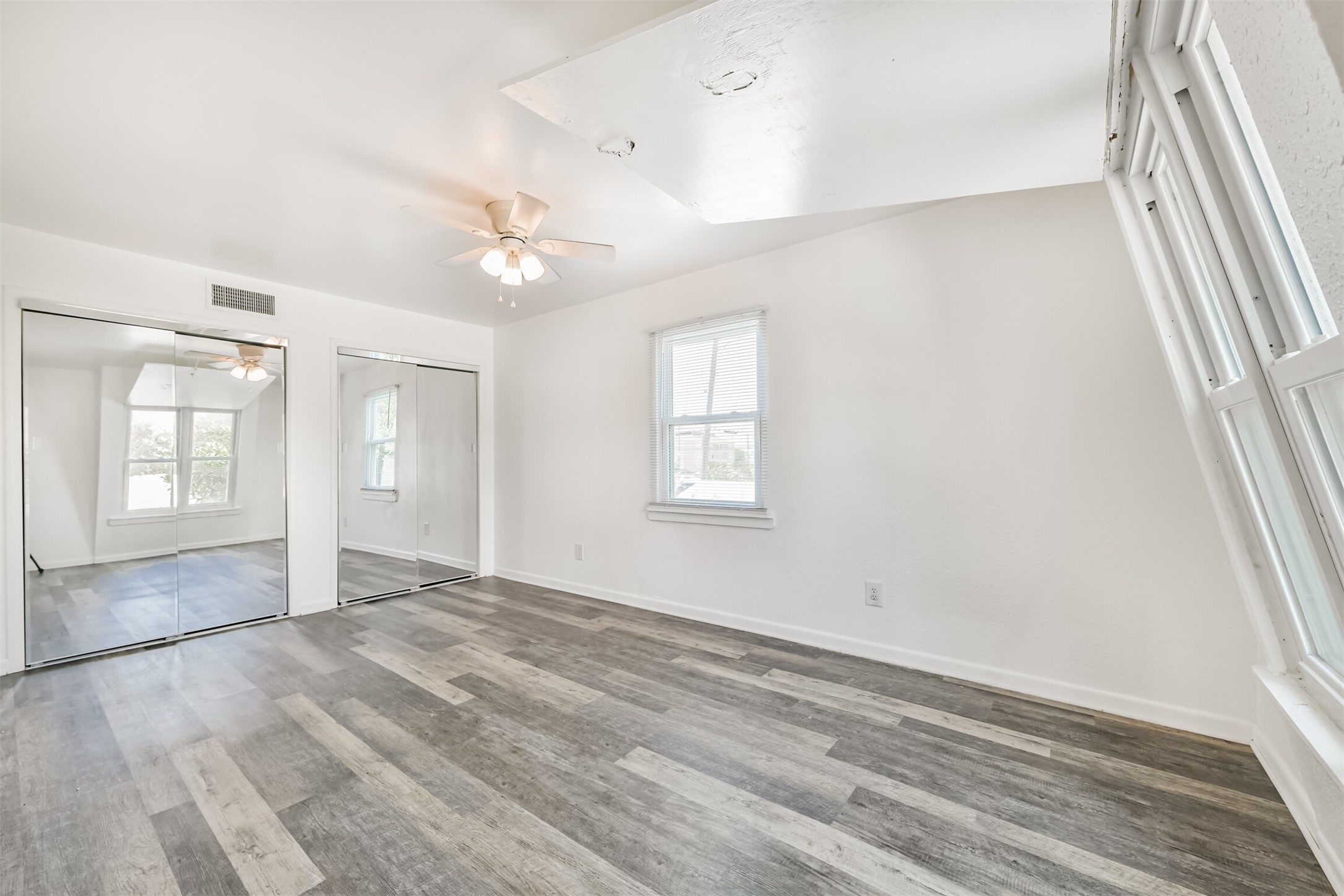 123 Strand Street, Unit REAR Galveston, TX 77550 - Photo 12 of 24 wooden floor in an empty room with a window