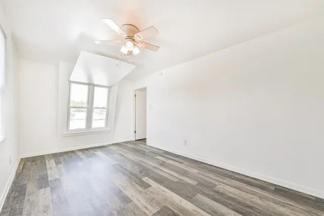 wooden floor in an empty room with a window