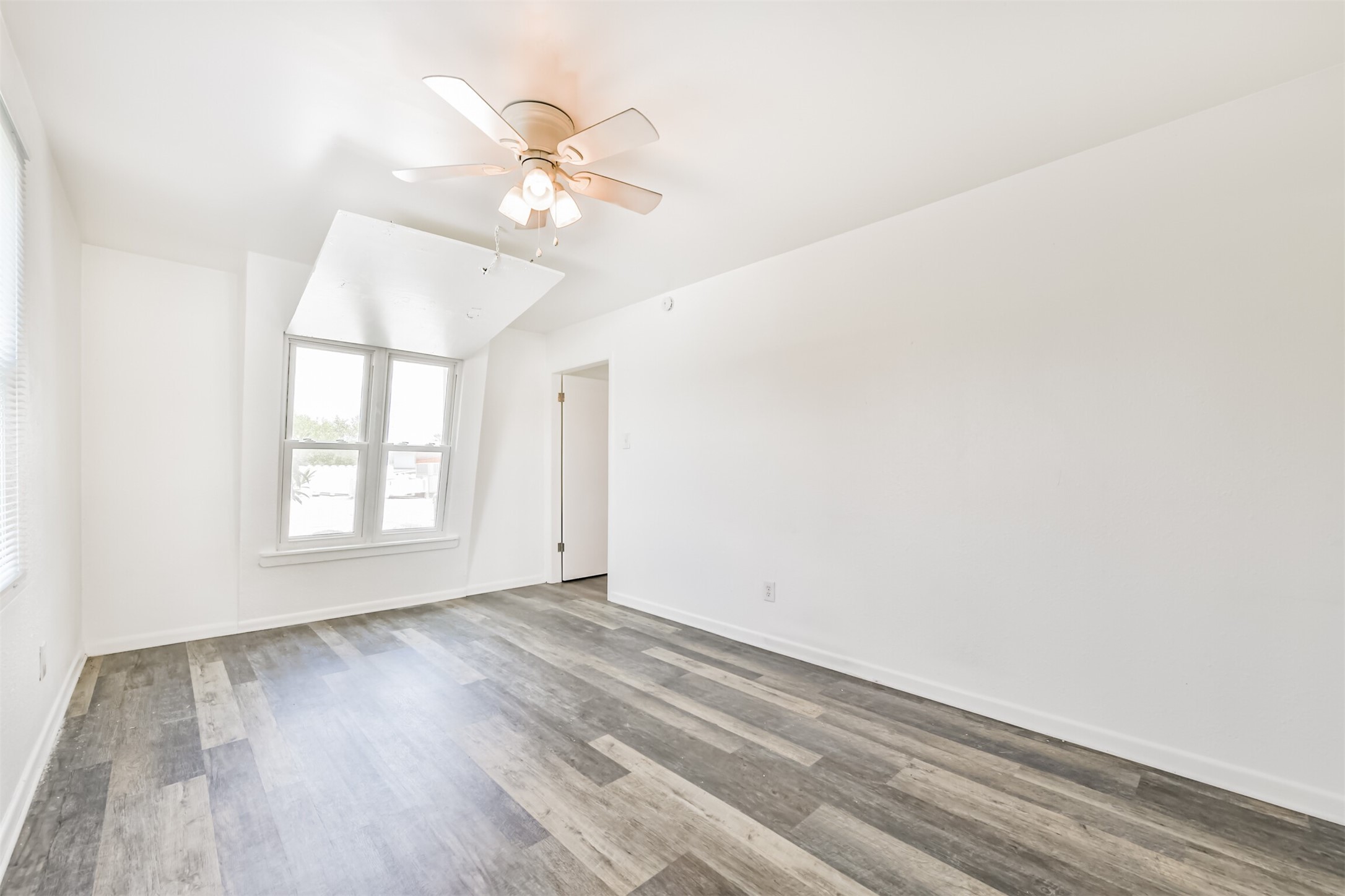 123 Strand Street, Unit REAR Galveston, TX 77550 - Photo 13 of 24 wooden floor in an empty room with a window