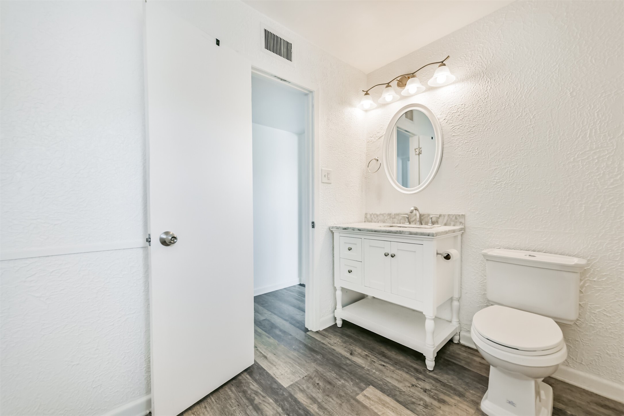 123 Strand Street, Unit REAR Galveston, TX 77550 - Photo 20 of 24 a spacious bathroom with a toilet sink and mirror
