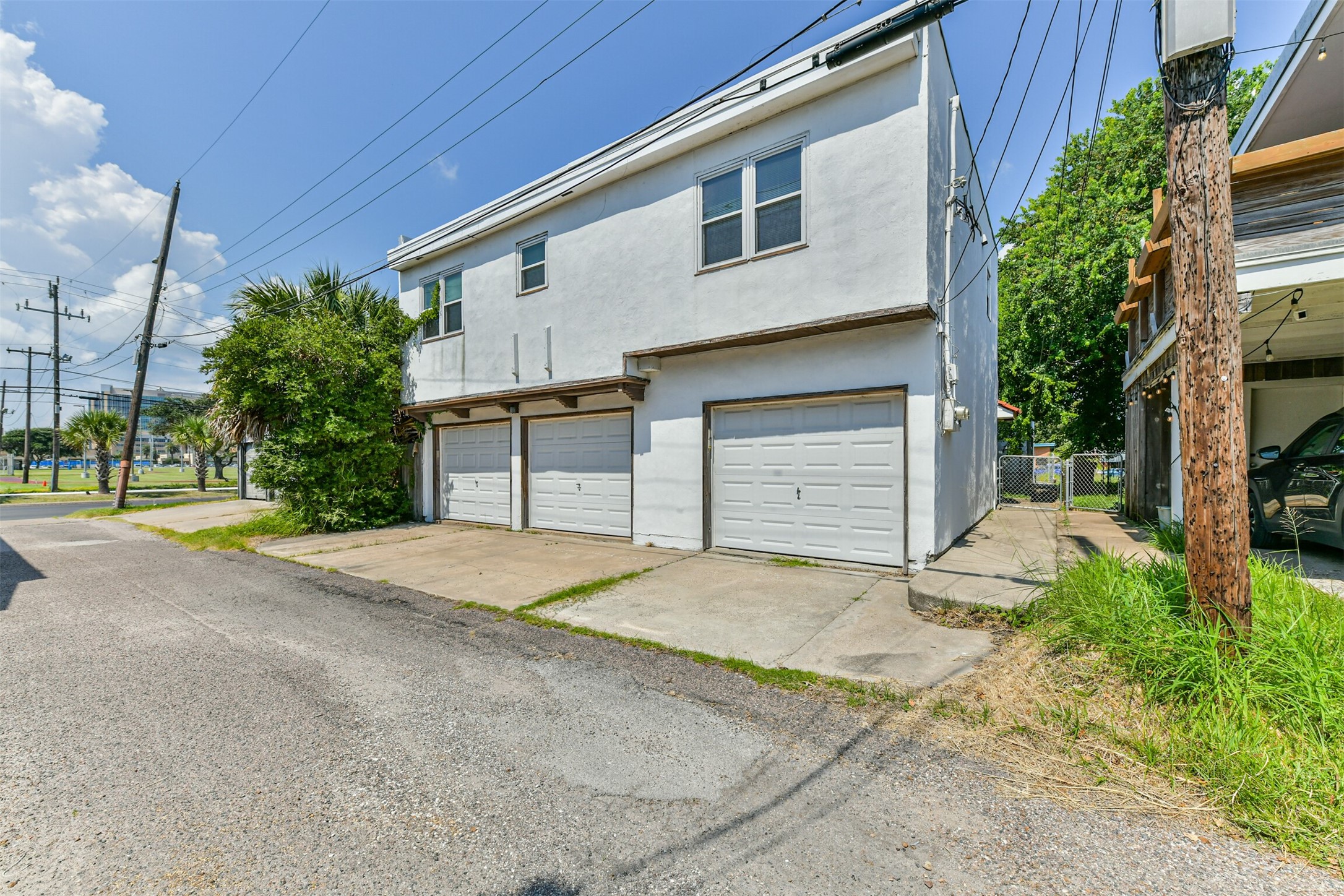 123 Strand Street, Unit REAR Galveston, TX 77550 - Photo 2 of 24 a front view of a house with a yard and garage