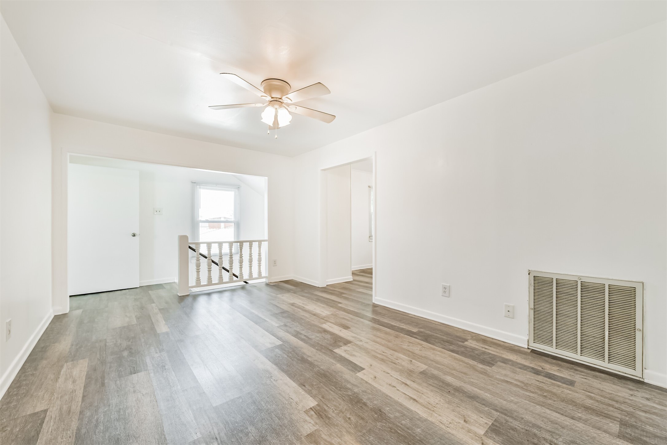 123 Strand Street, Unit REAR Galveston, TX 77550 - Photo 5 of 24 a view of an empty room with wooden floor and a window