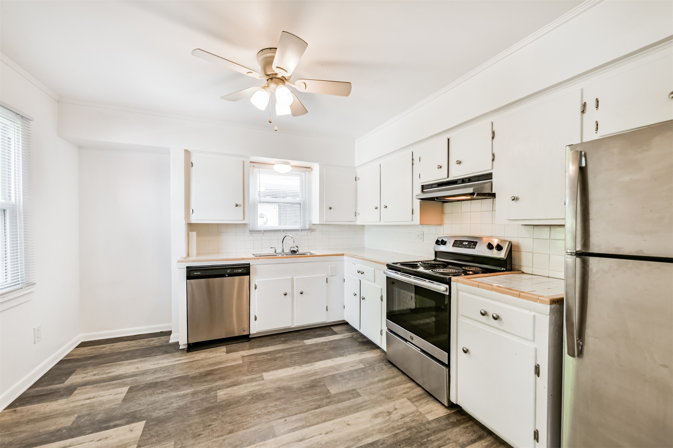123 Strand Street, Unit REAR Galveston, TX 77550 - Photo 7 of 24 a kitchen with cabinets stainless steel appliances and a window