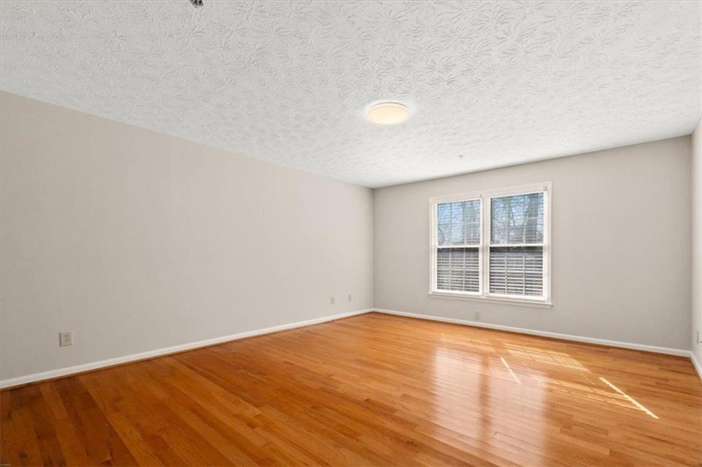 1411 Oakridge Circle Decatur, GA 30033 - Photo 18 of 26 wooden floor in an empty room with a window