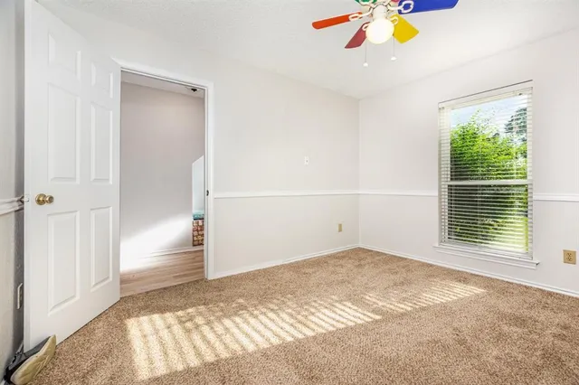 a bedroom with a bed a dresser and book shelf