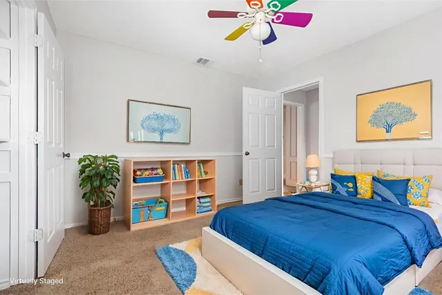 a view of an empty room with a ceiling fan
