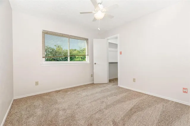 a room with a table chairs and a potted plant