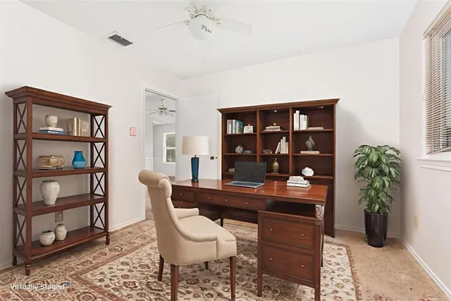 an empty room with a ceiling fan and a window