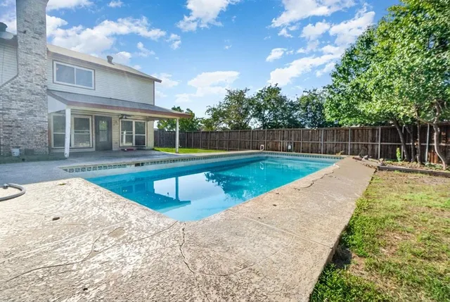a view of a house with swimming pool and sitting area