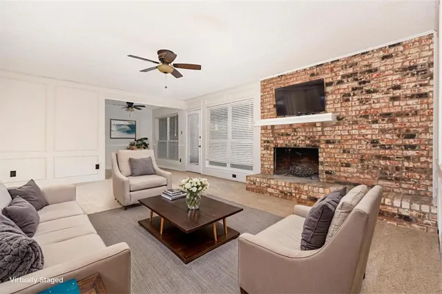 a living room with furniture a flat screen tv and a fireplace