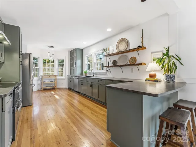 a kitchen with stainless steel appliances granite countertop a sink and wooden cabinets