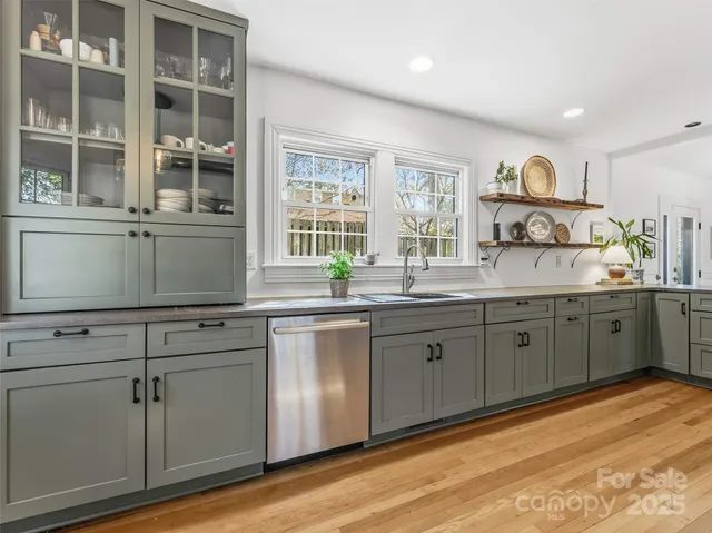 a kitchen with cabinets a sink and appliances