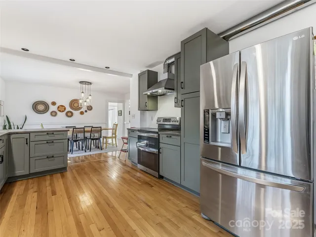a kitchen with stainless steel appliances a stove a refrigerator and cabinets