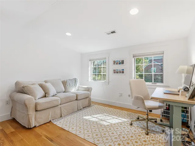 a living room with a couch and a table with wooden floor