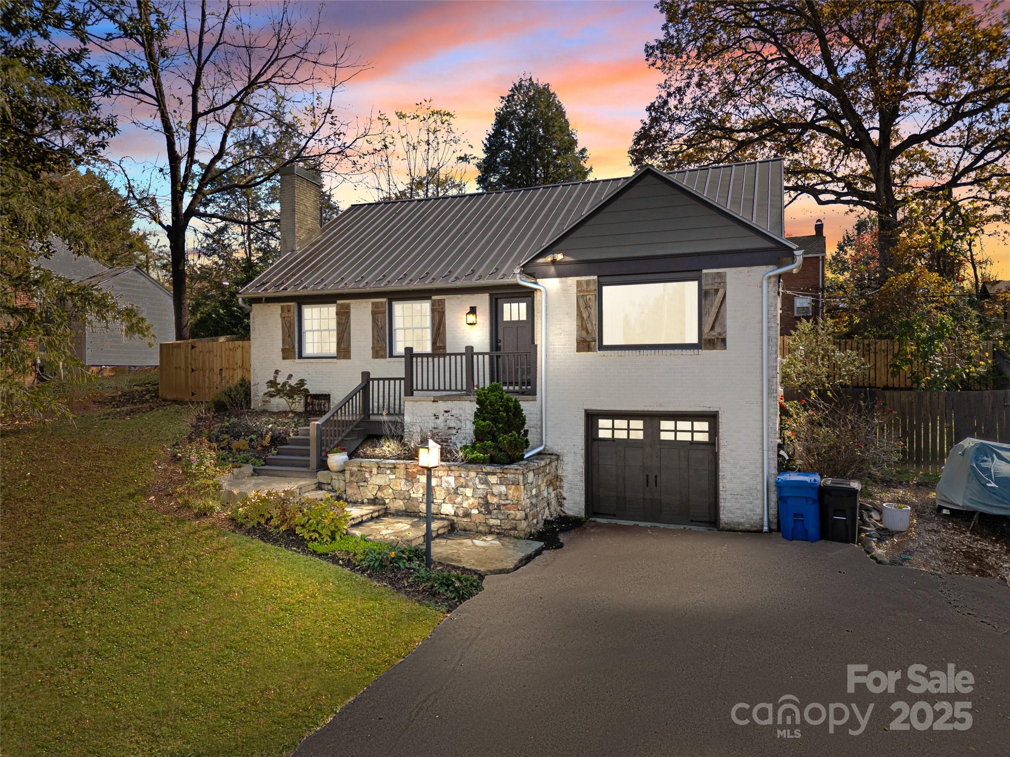 140 Lakeview Avenue Brevard, NC 28712 - Photo 37 of 37 a front view of a house with a yard and garage
