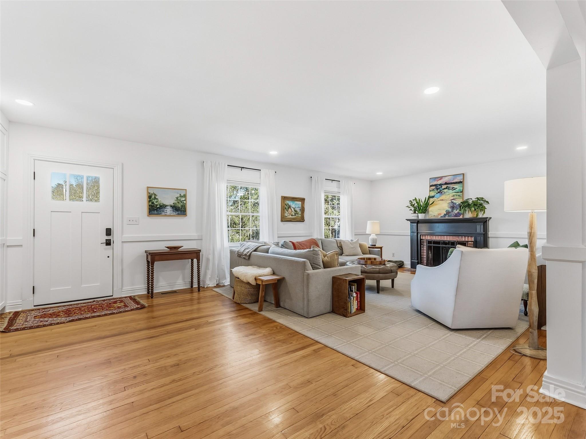 140 Lakeview Avenue Brevard, NC 28712 - Photo 5 of 37 a living room with fireplace furniture and a wooden floor