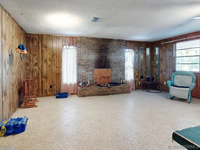 a view of a dining room with furniture and a chandelier