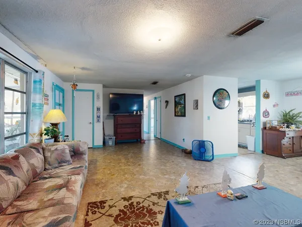 a kitchen with kitchen island a white counter top space and a sink