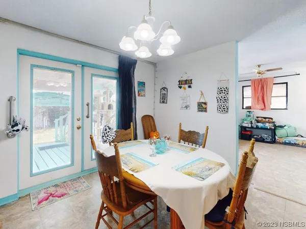 a view of a dining room with furniture and chandelier