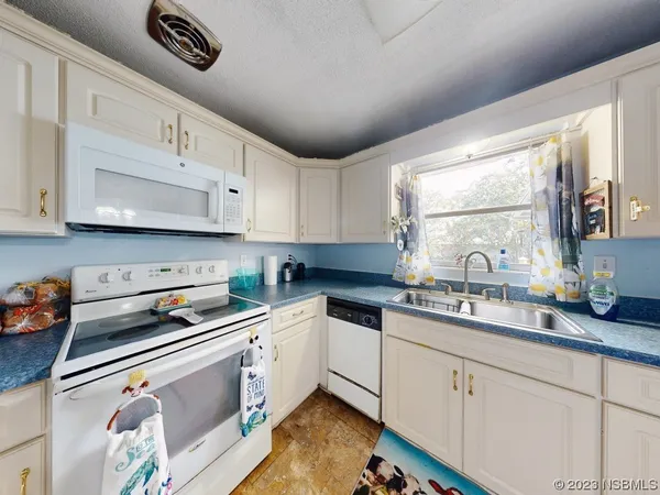 a view of a dining room with furniture and a chandelier