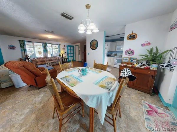 a bedroom with a bed and a large window with the outer view