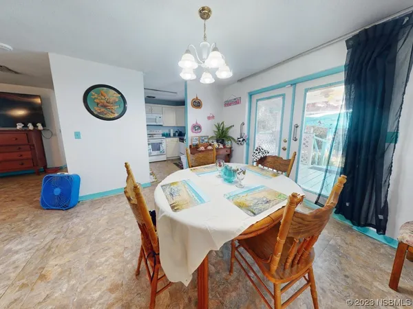 a bedroom with a bed and a dresser with wooden floor