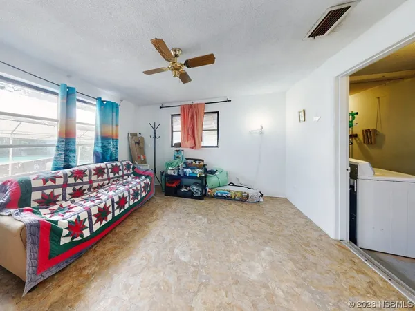 a bed sitting in a bedroom next to a window