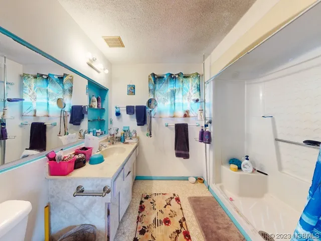 a view of a house with a yard and a patio