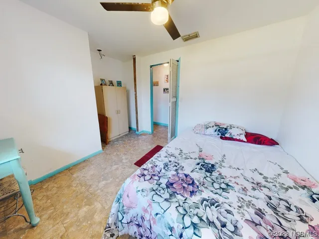 a view of a patio with table and chairs potted plants