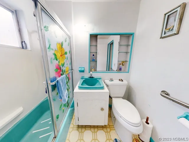 a view of a house with a big yard and potted plants