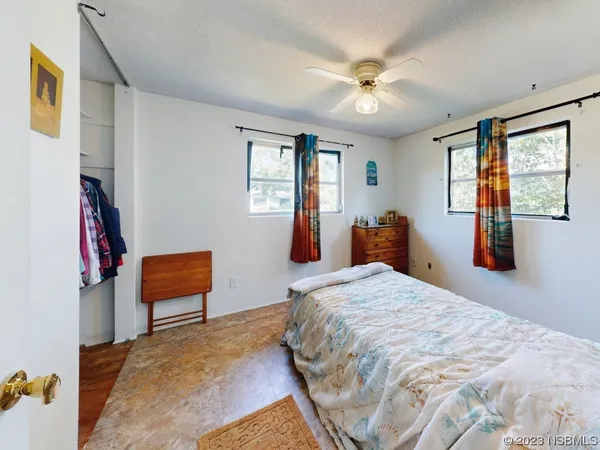 a view of a chair and table in backyard of the house