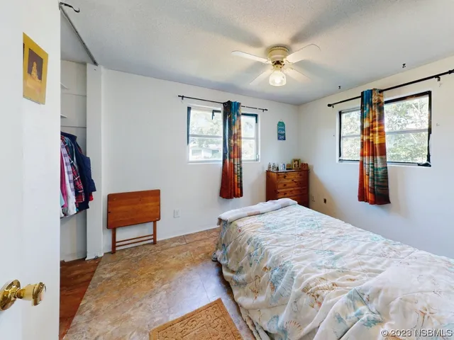 a view of a chair and table in backyard of the house