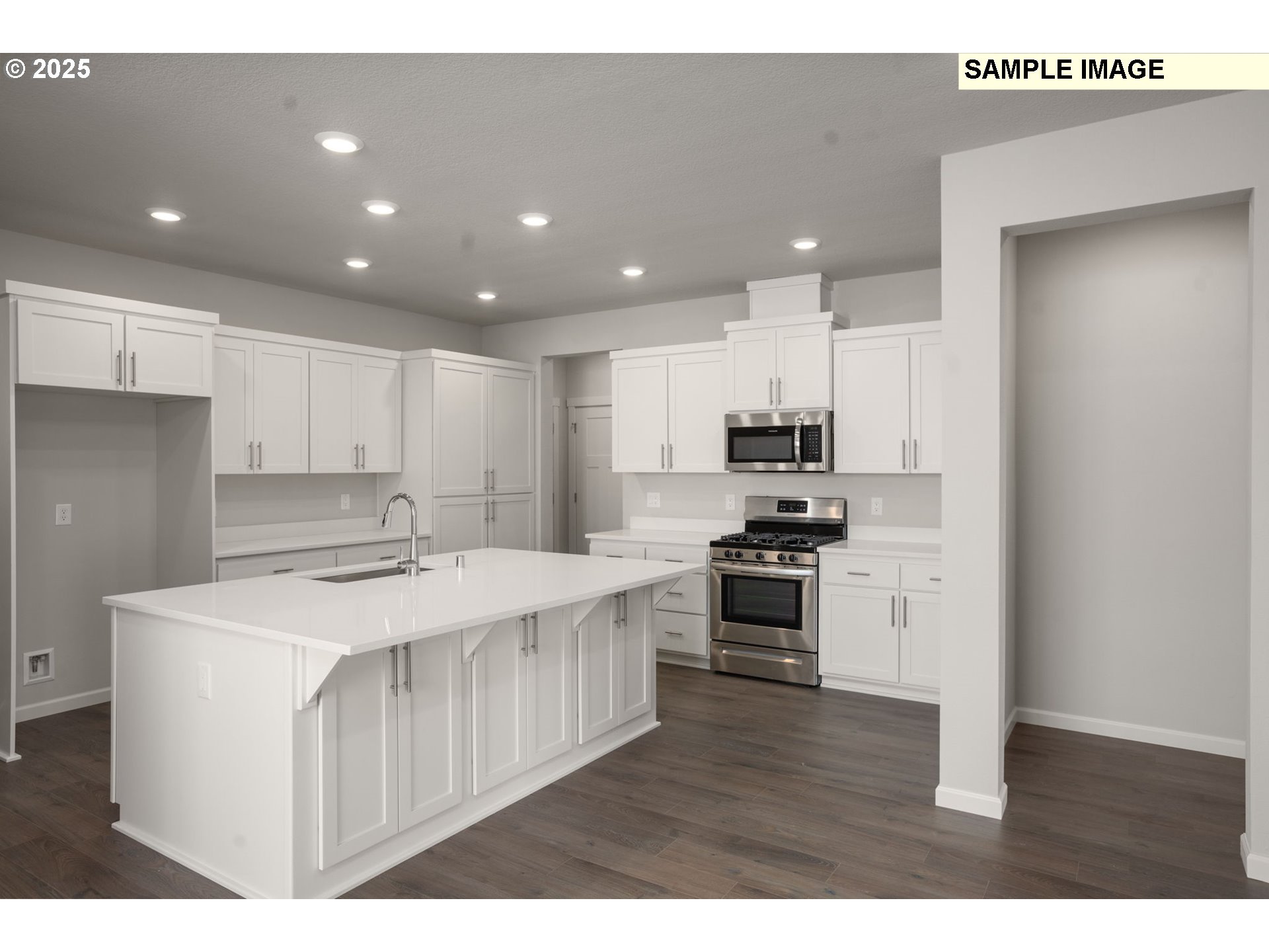 51086 Southwest Klompen Street Scappoose, OR 97056 - Photo 5 of 28 a kitchen with stainless steel appliances kitchen island granite countertop a stove top oven a sink and a refrigerator