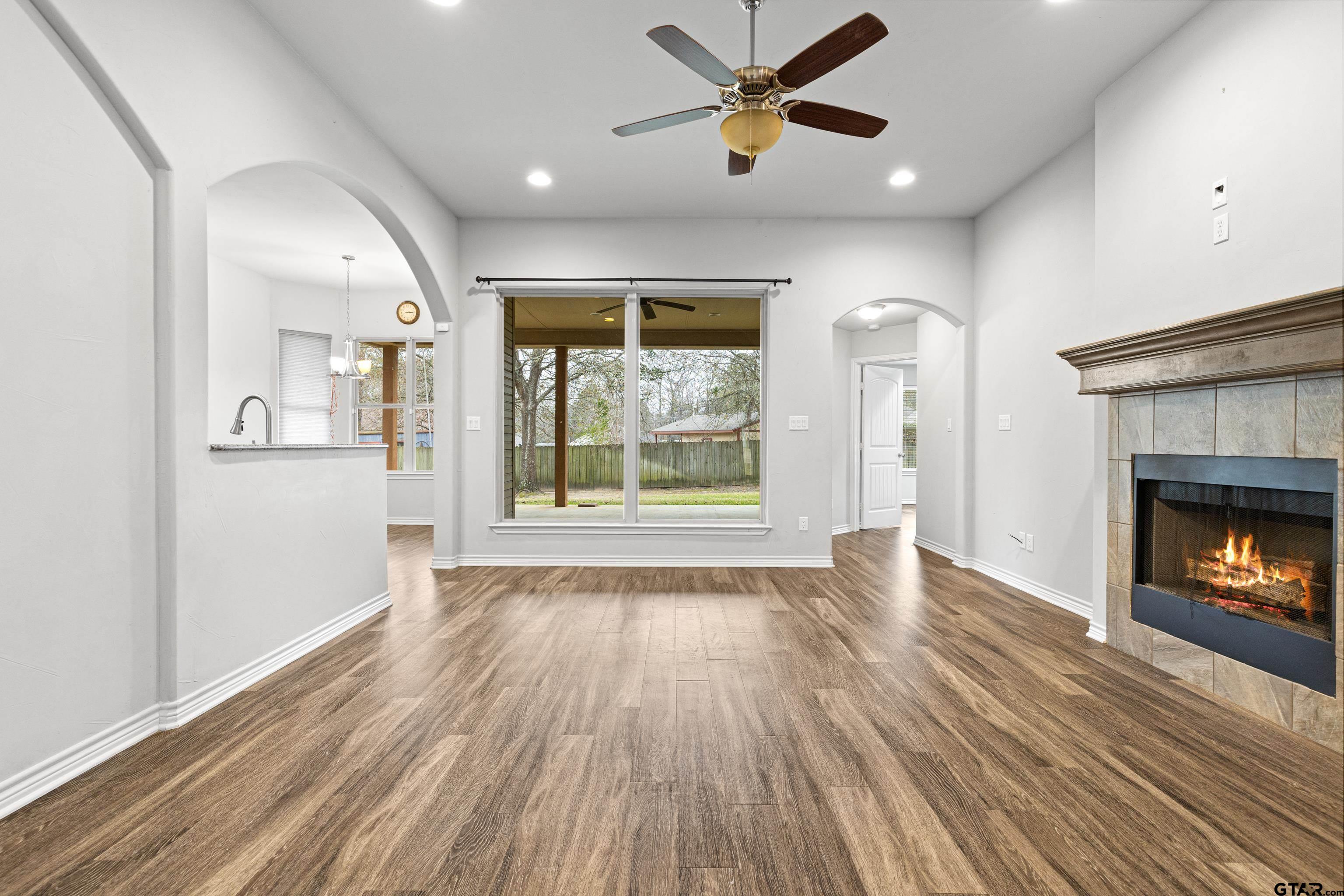 302 Collins Avenue Longview, TX 75605 - Photo 16 of 36 wooden floor in an empty room with a window