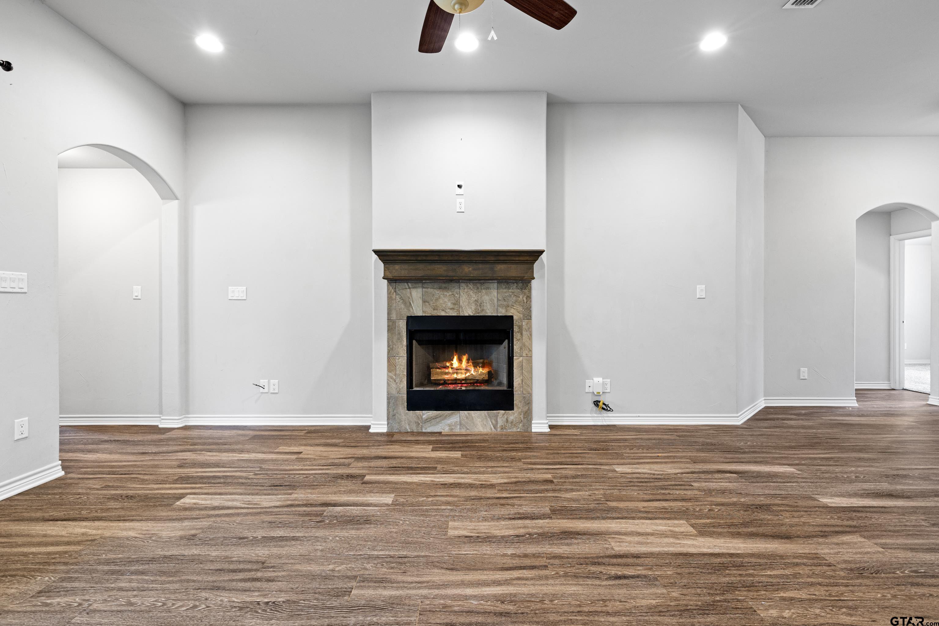 302 Collins Avenue Longview, TX 75605 - Photo 18 of 36 a view of an empty room with wooden floor and a fireplace
